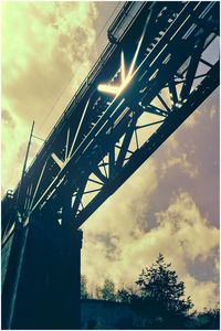 Low angle view of bridge against sky at sunset