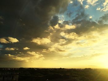 Scenic view of cityscape against cloudy sky