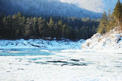 Scenic view of frozen lake with mountain in background