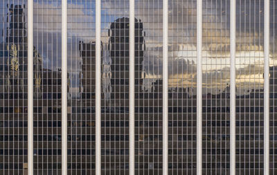 Low angle view of modern glass building in city