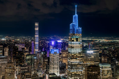 Manhattan - illuminated cityscape against sky at night