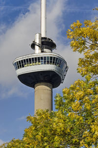 Iconic observation tower euromast rising above the trees in the park in autumn