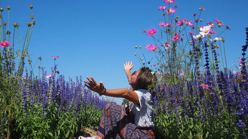 Rear view of woman holding flowers