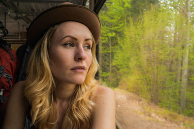 Close-up of young woman sitting in train