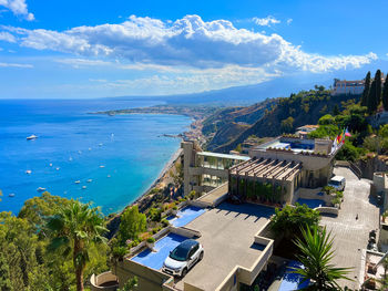 High angle view of townscape by sea against sky