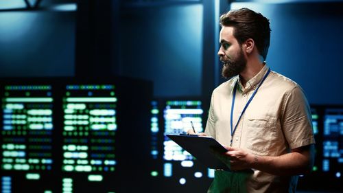 Side view of young man working in office