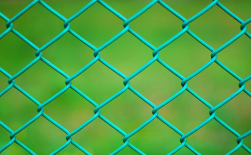 Close-up of chainlink fence at field