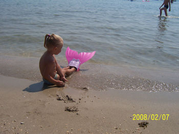 Full length of girl playing on beach