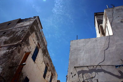 Low angle view of bell tower against blue sky