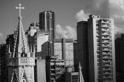 Buildings in city against sky