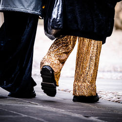 Low section of woman standing on street