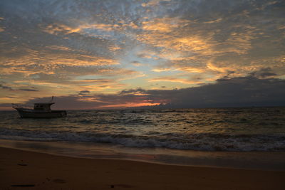 Scenic view of beach against sky during sunset