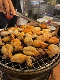 Close-up of person preparing food in container