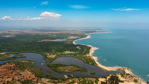 Aerial view of coastline of sri lanka with the ocean and beaches, agricultural lands and towns.