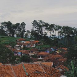 Houses against cloudy sky