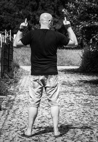 Rear view of man standing in water