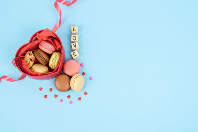High angle view of heart shape on table against blue background