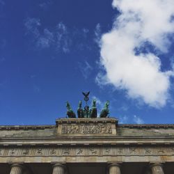 Low angle view of quadriga statue against blue sky