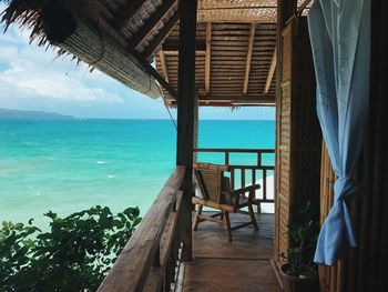 Balcony of hut against sea 