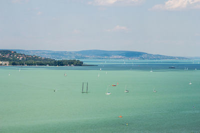 High angle view of sailboats by sea against sky