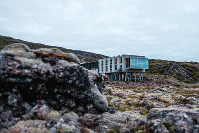 Rock formation amidst buildings against sky