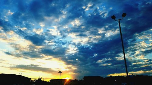 Low angle view of street light against cloudy sky