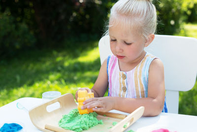 Close-up of girl holding ice cream in yard