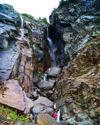 Scenic view of waterfall against sky