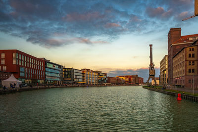 View of buildings against cloudy sky during sunset