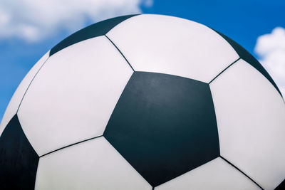 Close-up of soccer ball against sky