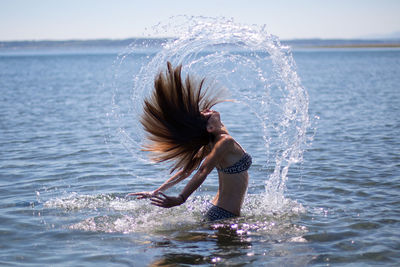 Close-up of boy playing in sea