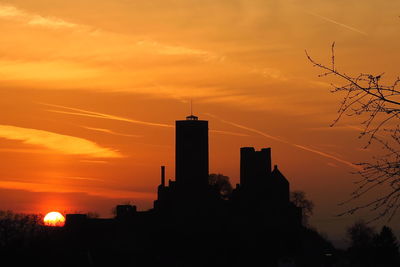 Silhouette buildings against sky during sunset