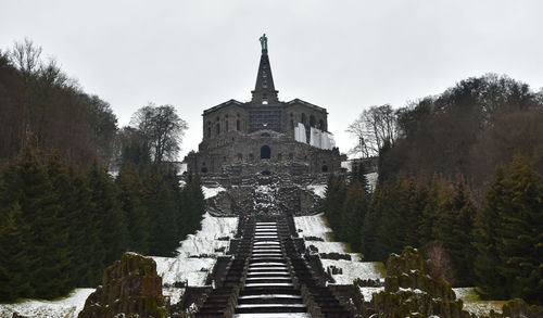 Panoramic view of buildings and trees against sky
