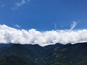 Scenic view of mountains against blue sky