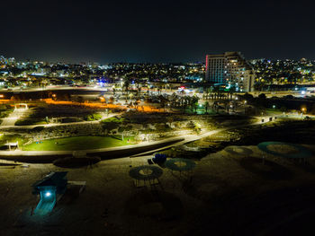 High angle view of illuminated city buildings at night