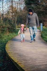 Full length of mother and daughter on tree
