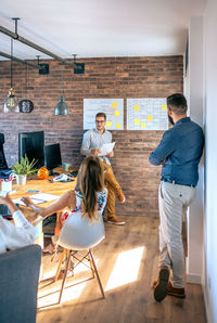 Coach giving a talk to workers in an office