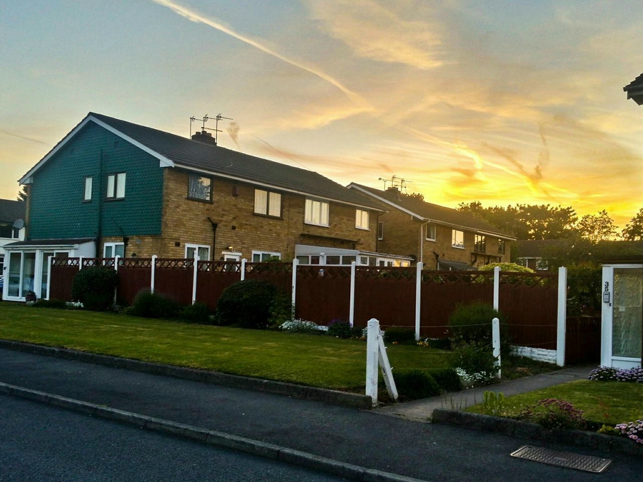 building exterior, architecture, built structure, sky, cloud - sky, house, sunset, street, residential structure, road, cloud, residential building, city, outdoors, street light, transportation, no people, cloudy, orange color, building