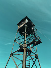 Low angle view of tower against blue sky