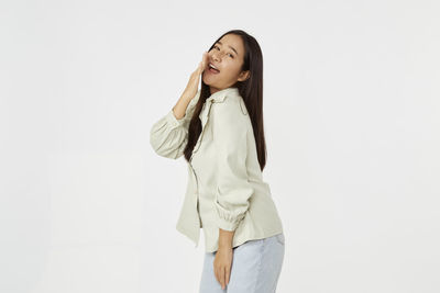 Portrait of a smiling young woman over white background