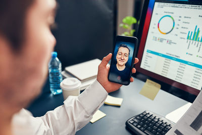 Man entrepreneur having business conversation on mobile phone. businessman working with data charts