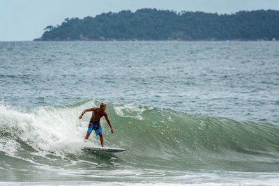 Full length of man surfing in sea