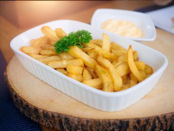 French fries with cheese in white plate