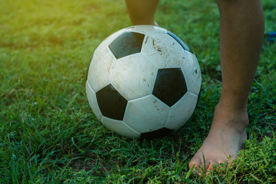 Low section of man standing on soccer field