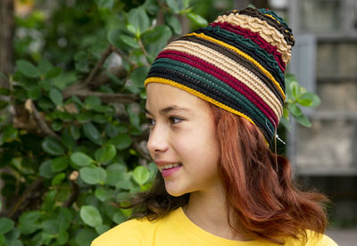 Beautiful girl model white teen  wearing a hat knitting face close-up