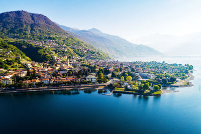 Scenic view of sea by town against sky