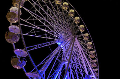 Low angle view of illuminated ferris wheel at night