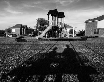 Built structure on field against sky in city