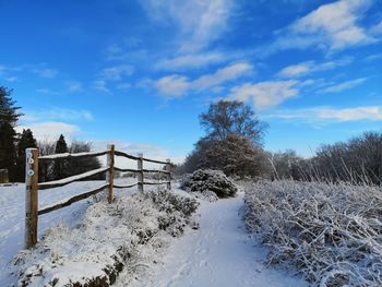 Snow covered field against sky