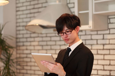 Close-up of businessman using digital tablet in office